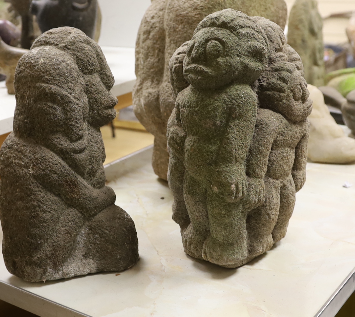 Three weathered Shona stone carvings, 1960s-70s; a figurative group, a figure and an animal, tallest 50cm